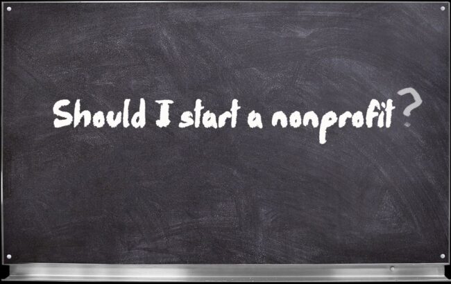 virtual chalkboard image with white text written in chalk that reads "Should I start a nonprofit?"