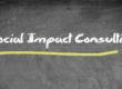virtual chalkboard that reads "Social Impact Consulting" in white chalk font with a yellow line underneath the words
